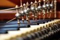 close-up of piano strings and tuning pegs