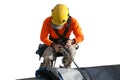 Rope access worker wearing yellow hard hat, long sleeve shirt, safety harness, working, at height abseiling with white background Royalty Free Stock Photo