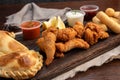 Close-up of a picada board with nuggets and tequenos with lemon slices and white and spicy sauces Royalty Free Stock Photo