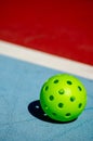 Close up of a pickleball on pickleball court