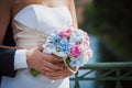 Close-up picture of bride`s and groom`s hands, holding each other and beautiful white and pink flower rose bouquet. Close-up Royalty Free Stock Photo