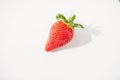 A close-up picture of a bright one red strawberry or berry as a fruit or food. white background is a naturally fresh fruit. Royalty Free Stock Photo