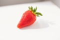 A close-up picture of a bright one red strawberry or berry as a fruit or food. white background is a naturally fresh fruit. Royalty Free Stock Photo