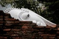 Close up picture of Buddha head behind the old brick wall. Royalty Free Stock Photo