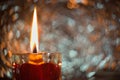 Close up Picture on the burning candle made from beeswax in the glass candle holder with red heart.