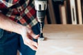 Man holding a drill on a wood plank Royalty Free Stock Photo