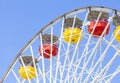 Close up picture of ferris wheel against blue sky.