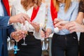 Close-up friends holding pretty Christmas sparklers on a blurred background. Sparkling bengal lights.