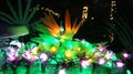 Close up picture of a flower of paradise made with fairy christmas lights shining at night in a garden