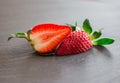 Close up picture of fresh red strawberries lying on a black stone table Royalty Free Stock Photo