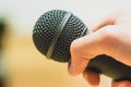 Interview: Journalist is holding a microphone in his hand. Close up Royalty Free Stock Photo