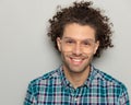 close up picture of happy man with curly hair wearing glasses and smiling Royalty Free Stock Photo