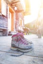 Trekking boots on the veranda of an alpine hut. Summer holidays in the mountains