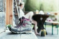 Trekking boots on the veranda of an alpine hut. Summer holidays in the mountains