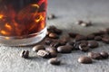 Close-up picture of iced coffee with Coffee beans in a gray background