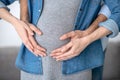 Close up picture of male hands touching womans pregnant abdomen Royalty Free Stock Photo