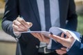 Close up picture of a mans hand signing the document