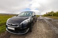 Close-up picture of a modern car on a bad road Royalty Free Stock Photo