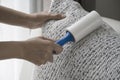 Close up picture people cleaning dirty sofa cloth with cleaning roller. Royalty Free Stock Photo