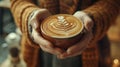 The close up picture of the person holding the cup of latte art coffee. AIG43.