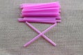 Close-up picture of pink plastic tube  on a sack cloth background  Concepts of using plastic tubes Royalty Free Stock Photo