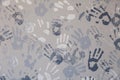 Close-up picture of a plurality of children\'s handprints painted on a gray wall. Textural background. Concept wall of memory in Royalty Free Stock Photo