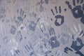 Close-up picture of a plurality of children\'s handprints painted on a gray wall. Textural background. Concept wall of memory in Royalty Free Stock Photo