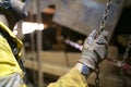 Close up picture of rigger hand commencing pulling a heavy duty chains block lifting load