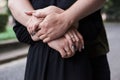 Close-up picture of romantic couple holding hands. A man is embracing a woman from behind. Romantic relationship concept. Mutual Royalty Free Stock Photo