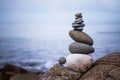 Balance, relaxation and wellness: Stone cairn outside, ocean in the blurry background Royalty Free Stock Photo