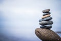 Balance, relaxation and wellness: Stone cairn outside, ocean in the blurry background