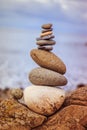 Balance, relaxation and wellness: Stone cairn outside, ocean in the blurry background Royalty Free Stock Photo