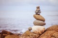 Balance, relaxation and wellness: Stone cairn outside, ocean in the blurry background Royalty Free Stock Photo