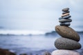 Balance, relaxation and wellness: Stone cairn outside, ocean in the blurry background Royalty Free Stock Photo