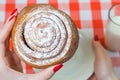 Close up picture of sweety tasty cinnamon roll in woman`s hand Royalty Free Stock Photo