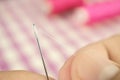 Finger hold white thread focus to push through the sewing needle Royalty Free Stock Photo