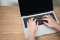 Close-up picture, top view of the hand, people are using a laptop on a brown wood table Royalty Free Stock Photo