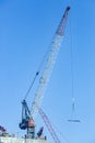 Close up picture of tower crane on top of highrise building construction site in Dubai Royalty Free Stock Photo