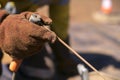 Close up picture of welder wearing a red welding safety glove protection with stick welding rod Royalty Free Stock Photo