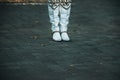 Close up picture of a woman's boots on the alleway