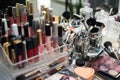 Close-up picture of workplace with make-up tools on table in beauty salon. Professional lipsticks and brushes for work of make-up