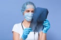 Close up picture of young woman doctor who analysis x ray orthopantomogram, panoramic radiography, attractive female in gloves, Royalty Free Stock Photo