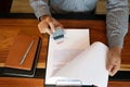 Close-up pictures of the hands of businessmen signing and stamping in approved contract forms