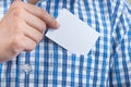 Close-up pictures of young businessmen picking business cards out of a blue plaid shirt