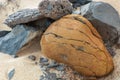 Close-up picturesque image of different stones or rocks on sand in desert