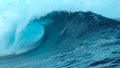 CLOSE UP: Picturesque tube wave crashes wildly and splashes ocean water in air. Royalty Free Stock Photo