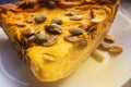 Close-up of a piece of freshly baked pumpkin pie sprinkled with pumpkin seeds for Thanksgiving or the holiday home treat Royalty Free Stock Photo