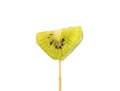 Close-up of a piece of kiwi fruit on a wooden stick over a white background.