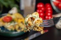 Close-up, piece of omelet with cheese and mushrooms on a fork Royalty Free Stock Photo