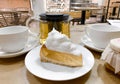 Close-up of piece transparent gelatin cake shortbread dough with meringue cream on table in cafe